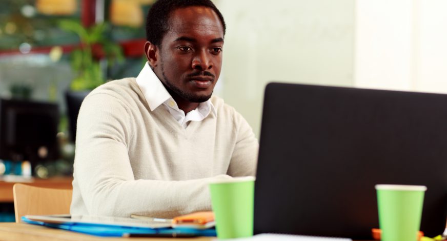 African american businessman working on his laptop in office